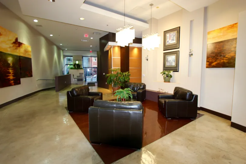 Hall decorated with sofa, plants and photo frames in the building in Trellis