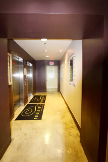 a Hallway view with an elevator and staircase door in background in Trellis