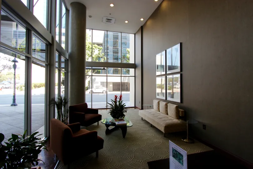 THE ROOM IN THE TREO WITH SOFAS, TABLES, PAINTINGS, CAR, ARTIFICIAL FLOWER.