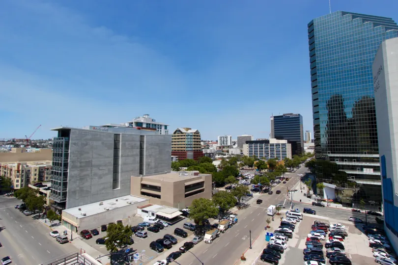Tall gray residential structures next to a parking garage in Downtown San Diego at TREO