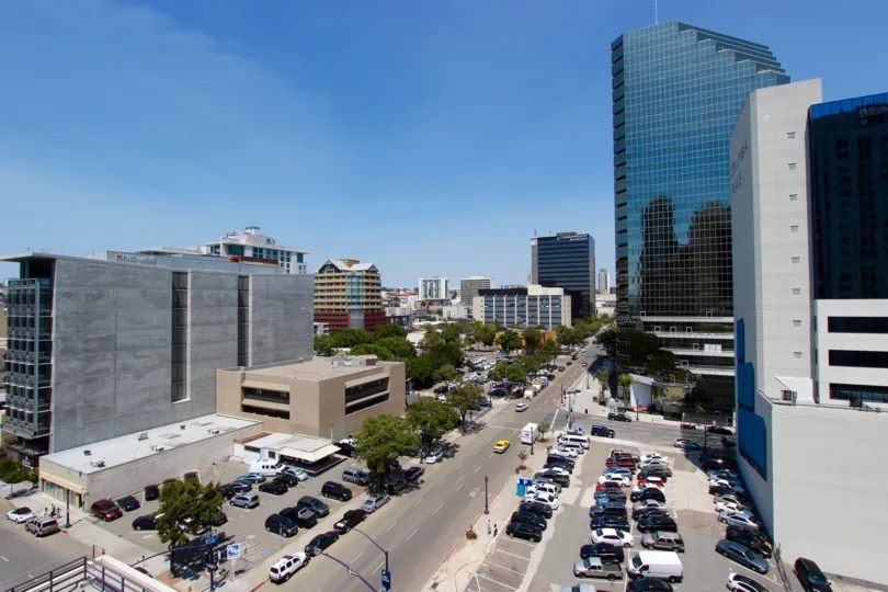 Tall glass building with an antennae on top of it at TREO in Downtown San Diego CA