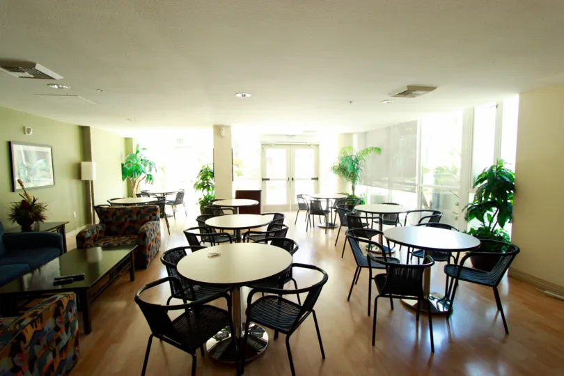 Inside of a building with lots of tables in chairs in TREO