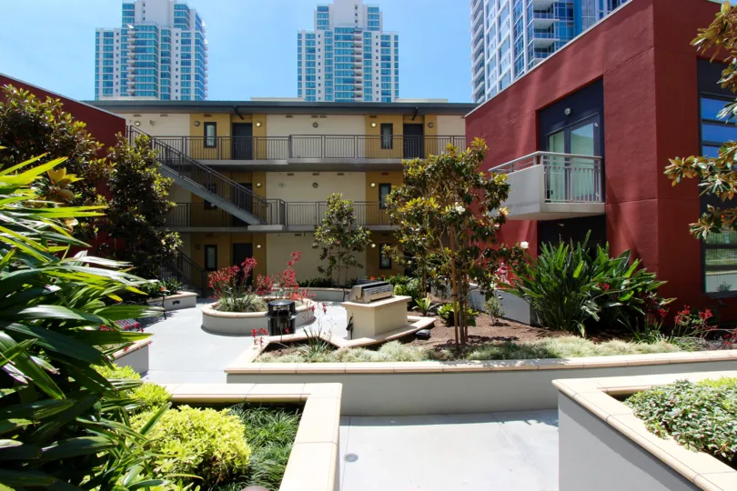 Courtyard at TREO with trees and skyline in the background in Downtown San Diego, California
