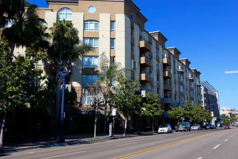 Union Square, City: Downtown San Diego, a road and a row of buildings looking beautiful and there are lot of cars parked on the road.
