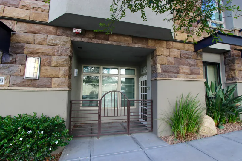 Secured entryway flanked by greenery at Union Square in Downtown San Diego, California.