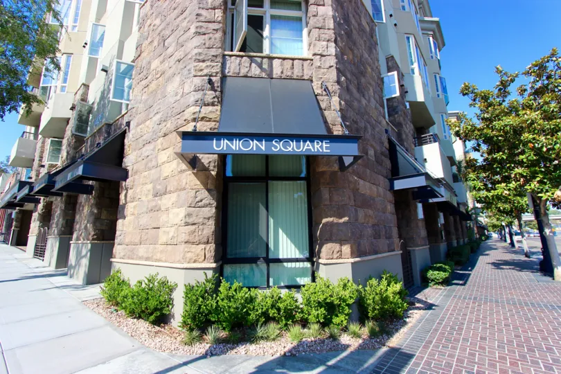 A radiant and sunny day at the Union Square with a resplendent exterior view of the old-fashioned rock-walled architecture and classic fusion touch of the modern and the old