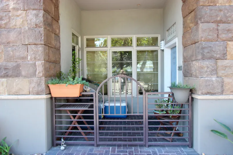 A radiant and warm day at the union square with a delightful view of the Entrance showcasing the windows and doors and potted plants
