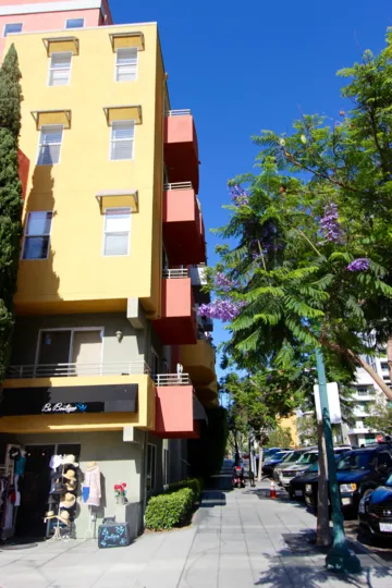 a building with a colorful paint job with cars parked in front of it in Village Walk