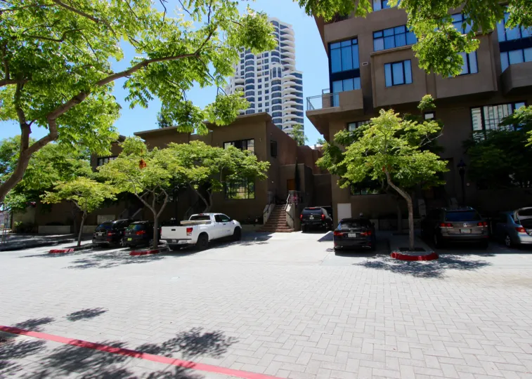 THE APARTMENT IN THE WATERMARK WITH THE CAR PARKING, TREES, GLASS WINDOWS.