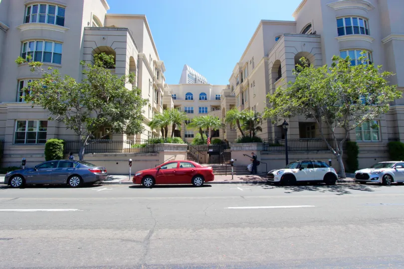 The sun shines over the large tan building in the Watermark area in San Diego.