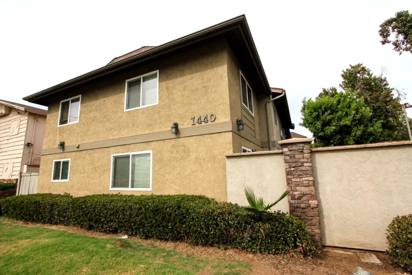 Tan stucco house #1440 in the Arbors of Oakdale community in El Cajon, California