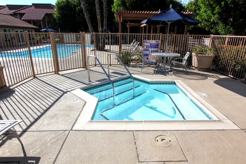 A pool view in the Cottage Villas with swimming pool and out door chairs.