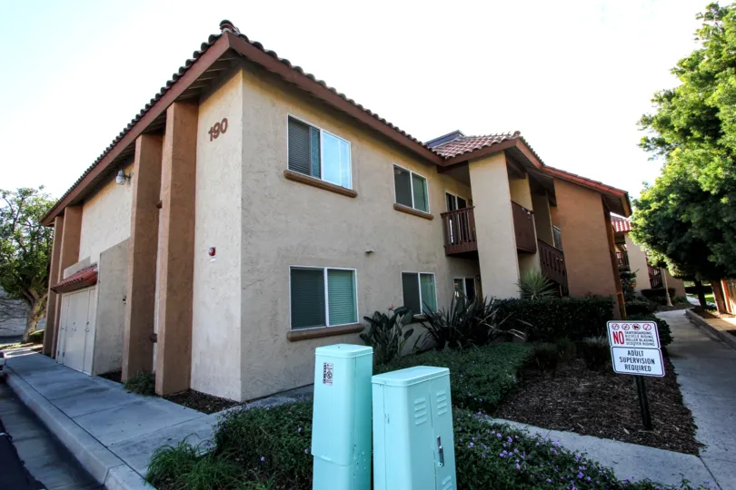 A brown apartment building in Artesia neighborhood of El Cajon, CA in a sunny day