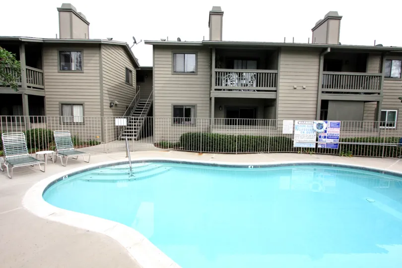Two story apartment buildings above a swimming pool at Broadway Timbers in El Cajon California