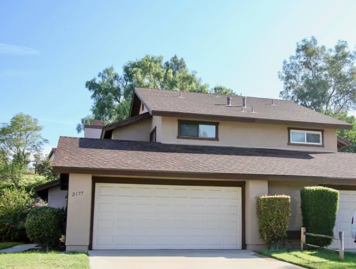 Outer View of a house in the Cottonwood Meadows with view of the Garage door.