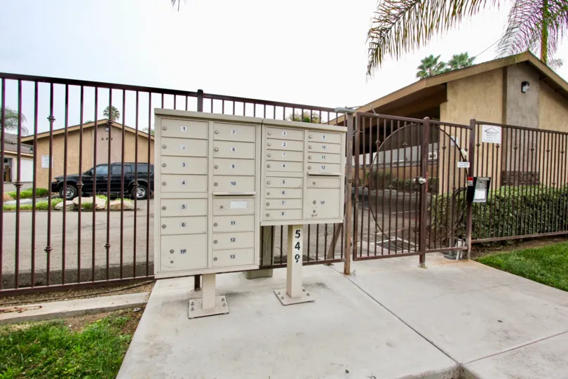 Mail boxes near security fence at El Palacio in El Cajon California