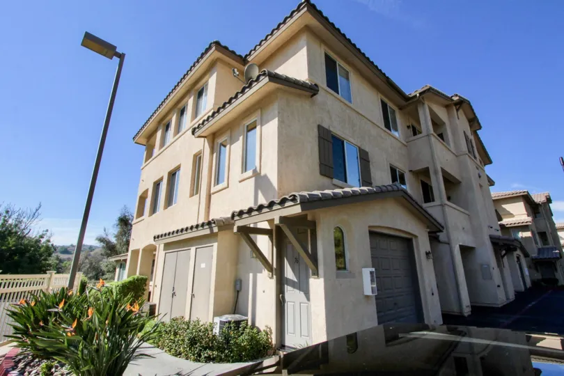 A three-story home with beautiful flower garden in the Fairway Villas community of El Cajon, California