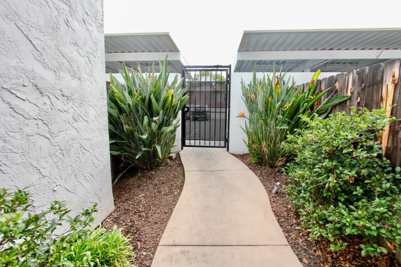 A beautiful walkway filled with plants in the Granite View Villas housing community