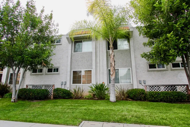 A residence in Granite View Villas with different trees in front of it.