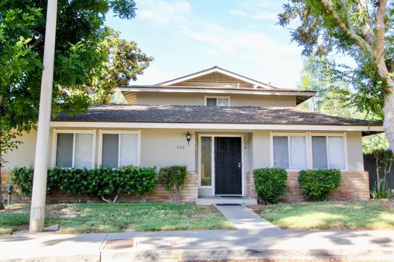 House in Jamacha Greens with landscaped front yard with several mature trees