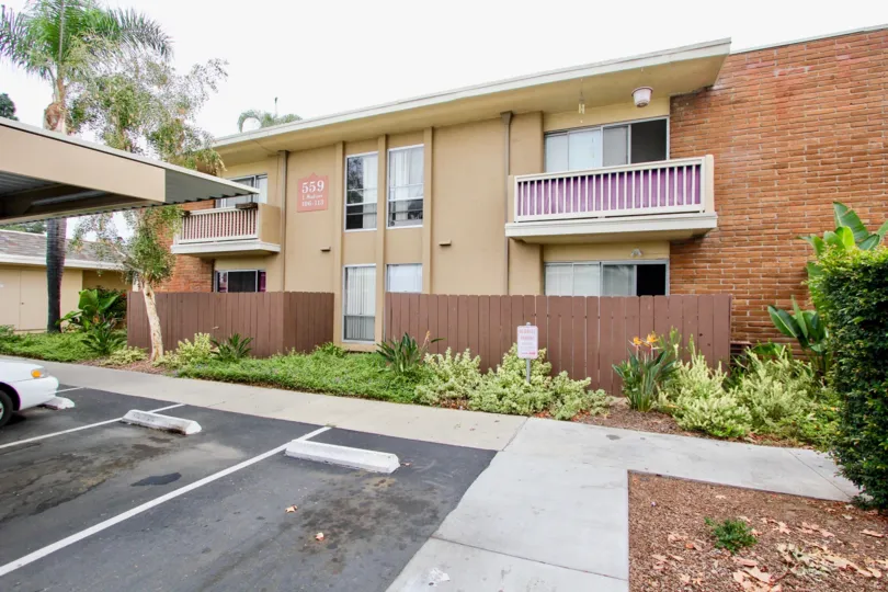 Madison Ave Condos - A residential community located in El Cajon, CA. Pictured here are some units and the parking lot.