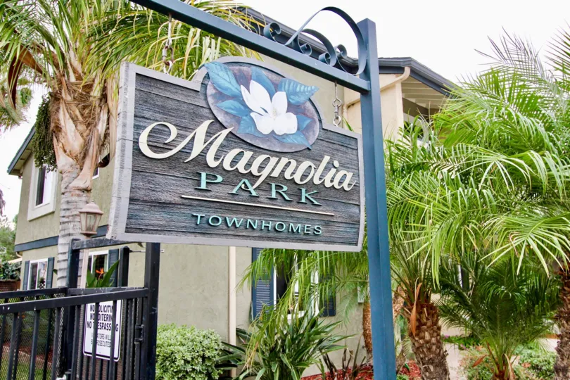 A sign indicating the Magnolia Park Townhomes, a residential community located in El Cajon, CA