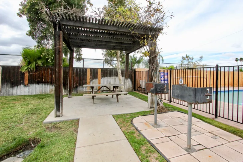 Swimming pool near picnic table at Maple Park Villas in El Cajon California.