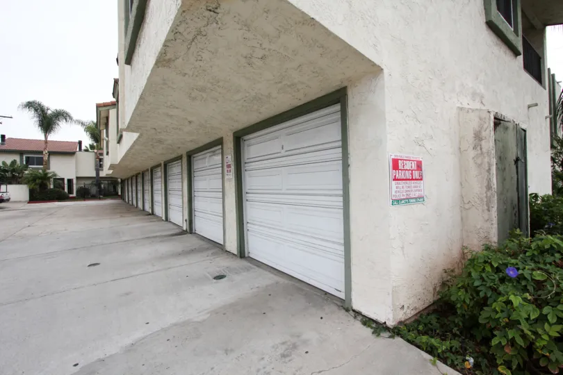 A red and white resident only parking sign on a garage in Mark Manor at El Cajon CA