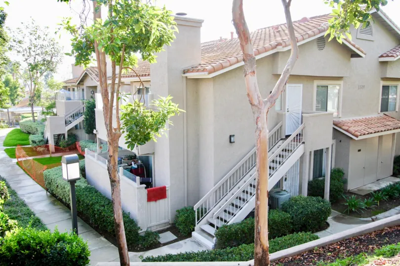 Two story residential building with attached stairway at Mirasol in El Cajon California