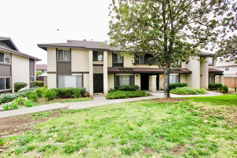 Two story housing with yard and trees at Mollison Villas in El Cajon California