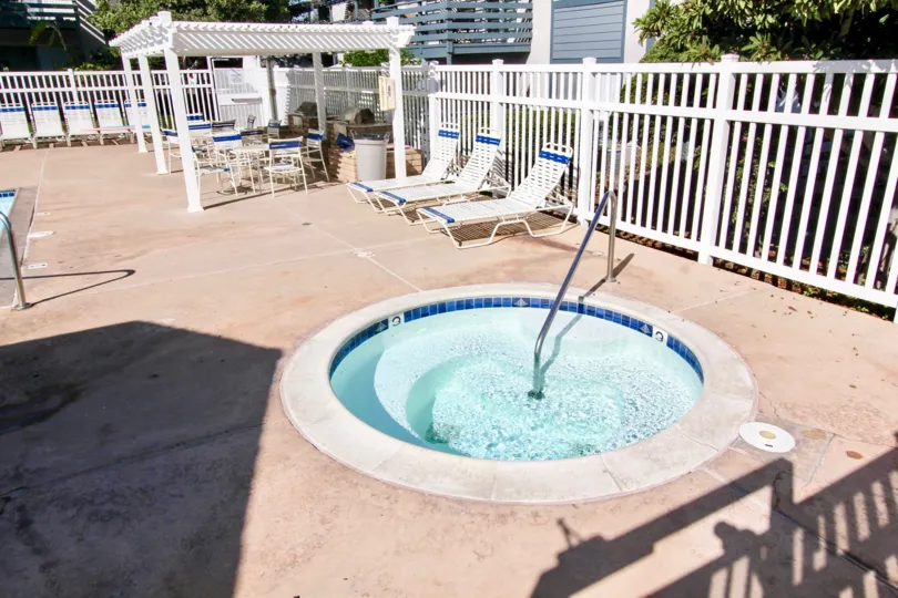 A suuny day with view of hot tun and lounge chairs in Mountain View Village.