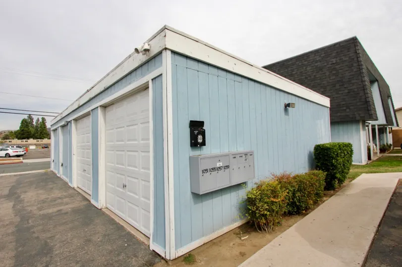 A blue garage on an overcast day in Hermosa Villas, a neighborhood in El Cajon, California