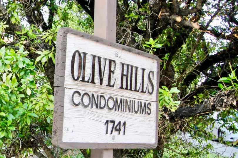 Condo sign in front of trees at Olive Hill in El Cajon CA