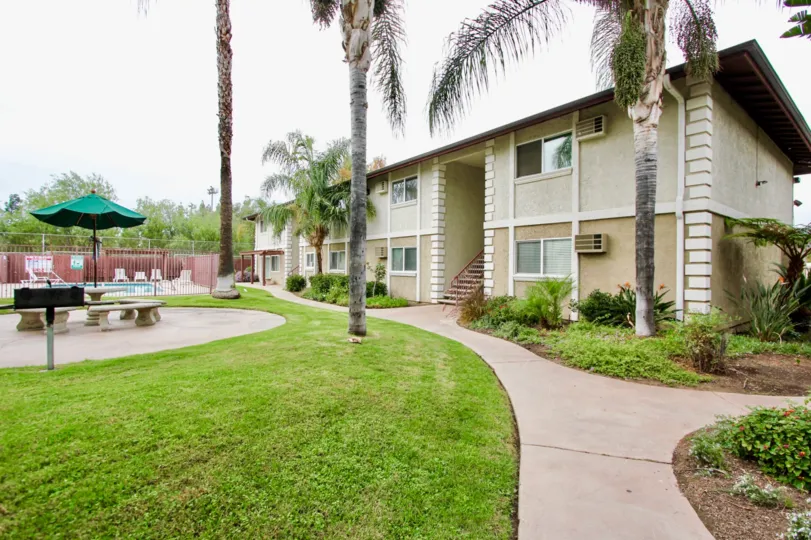 Common area including pool, BBQ, and eating area at Orlando Manor community in El Cajon, California
