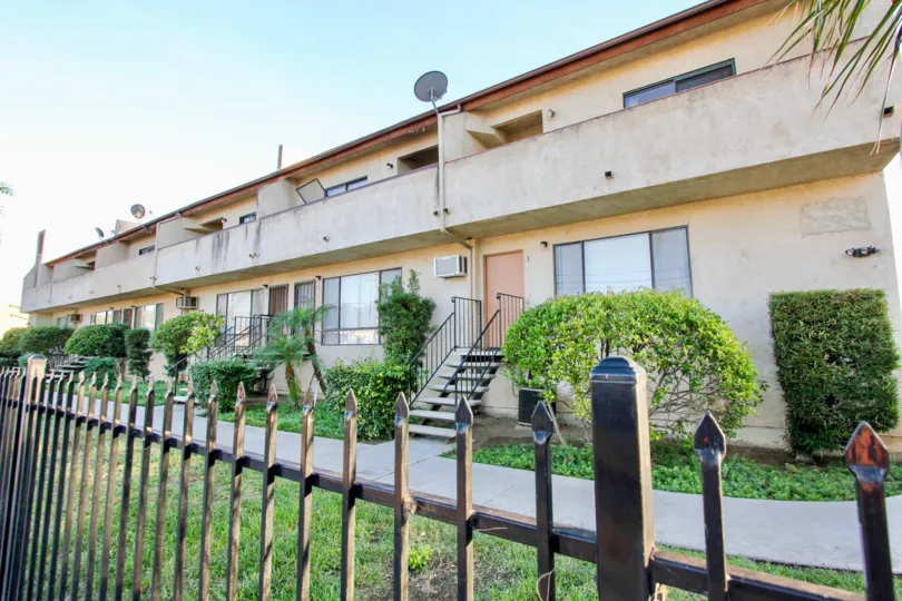 Two story apartments behind a black iron fence at Palaie Royal in El Cajon in California