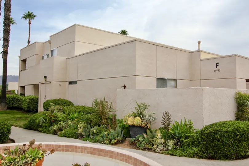 Two story housing units with plants at Palm court in El Cajon California