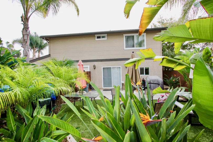 VERY BEAUTIFUL HOUSE. IN FRONT OF IT THERE ARE FOUR SMALL TREES. AND THERE IS A ROAD, VERY CLEAM.
