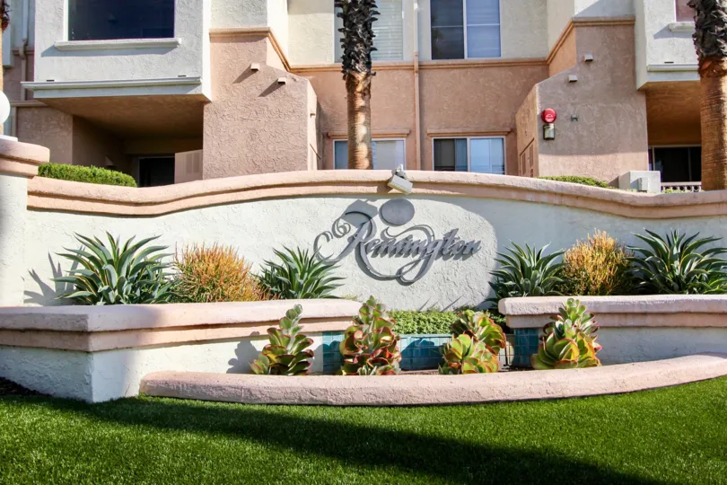 Remington sign, located in El Cajon California. Has green plants.
