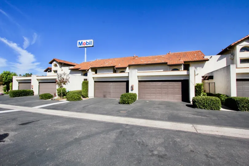 A mobil sign in the distance with four garages in the Sunet Hills Terrace area.