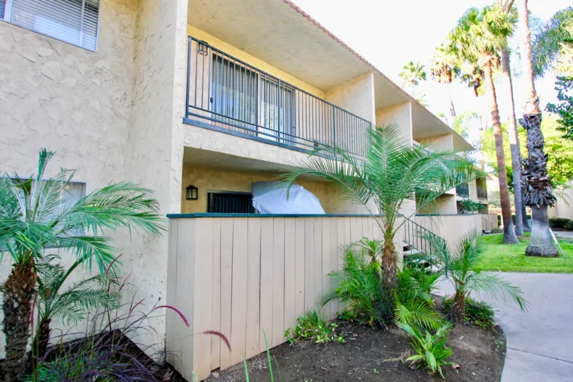 apartment building in Sunterra showing balcony, gardens and trees