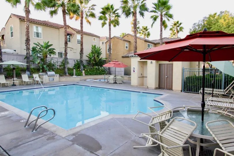 Tables and loungers line the pool at Teatro Community