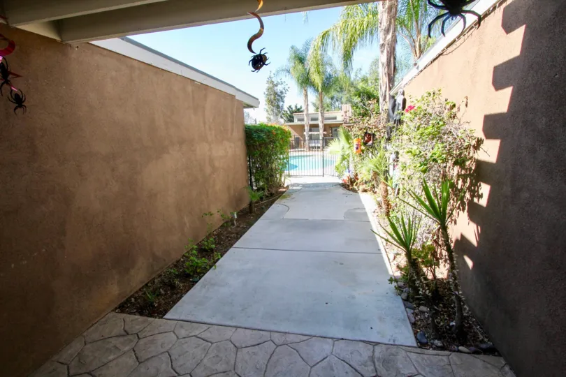 A covered walkway leading to a pool at the Courtyard on Ballard housing community