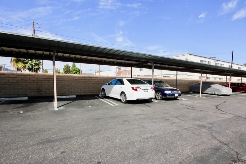 View of a parking space in The Willows, El Cajon, California showing different cars parked.