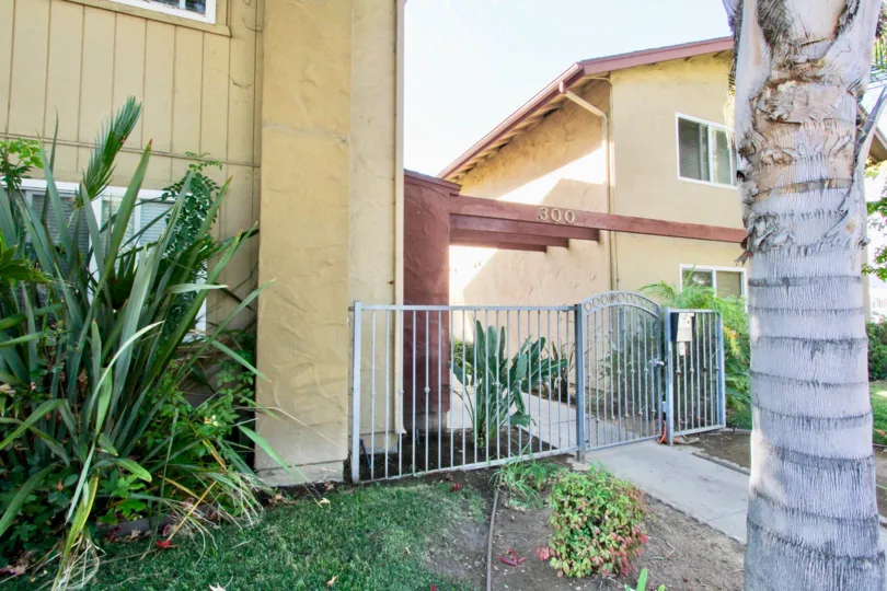 Black gate between residential buildings at Verde Villas in El Cajon California