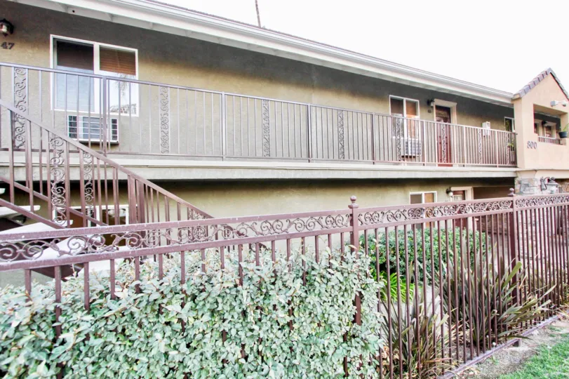 An apartment building with some bushes in Villa Grigio, El Cajon, CA