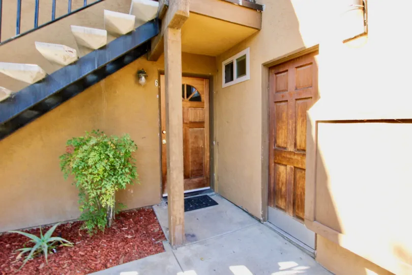 Multiple wooden doors as well as stairs to the second floor located in Villas at lexington.