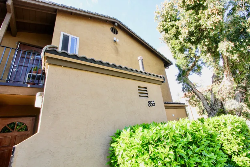 Two story housing near trees at Villas at Lexington in El Cajon California
