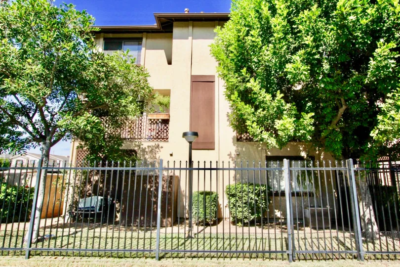 A sunny afternoon in the Vintage 81 area iron fence large house trees