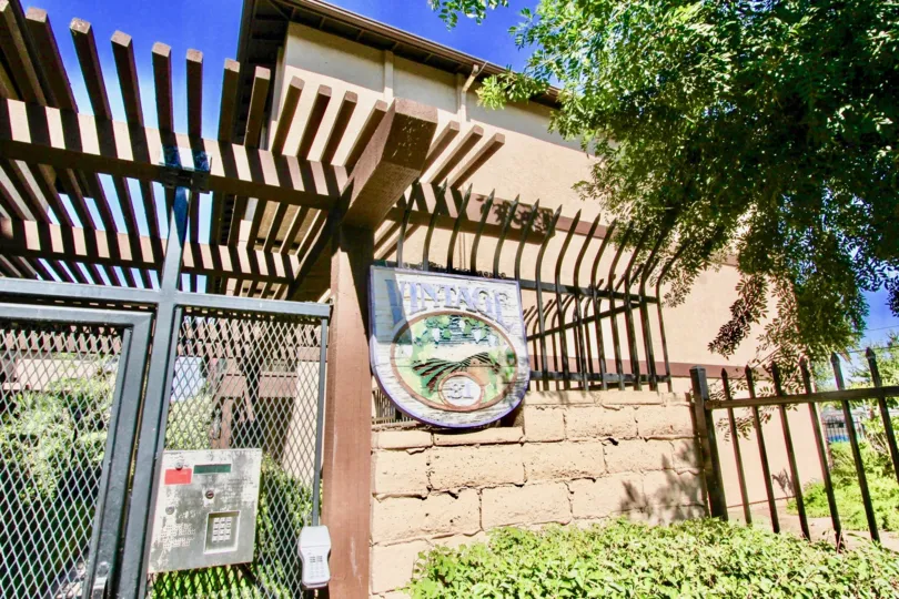 Housing unit with security gate and tree at Vintage 81 in El Cajon California
