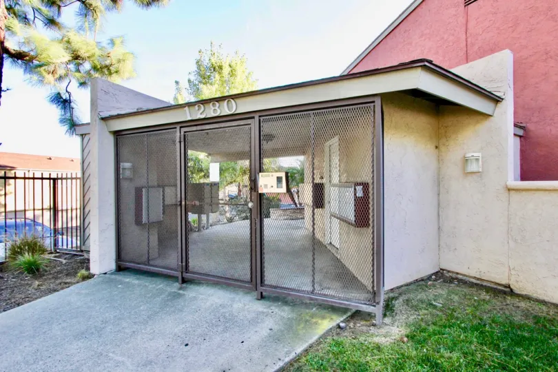 A secure entrance to flats in Vista Del Sol with locked gate and telecom.